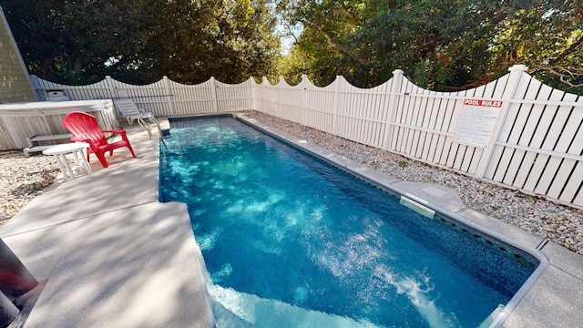 view of swimming pool with a fenced backyard and a fenced in pool