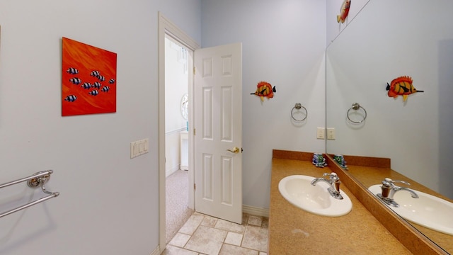 bathroom with baseboards and vanity