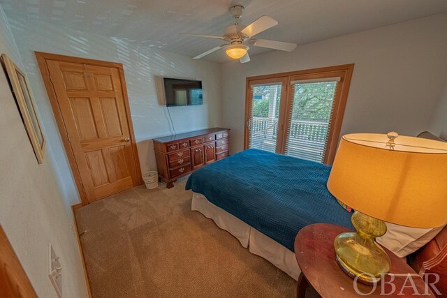 bedroom with access to exterior, a ceiling fan, and light colored carpet