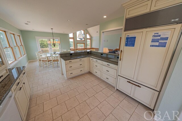 kitchen with dishwasher, a peninsula, paneled fridge, pendant lighting, and recessed lighting