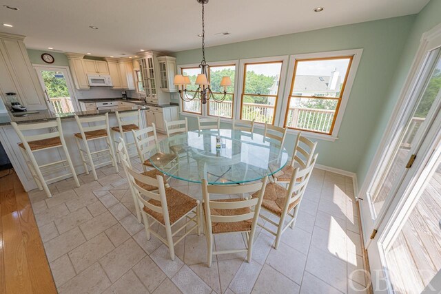 dining area with a notable chandelier, recessed lighting, visible vents, and baseboards