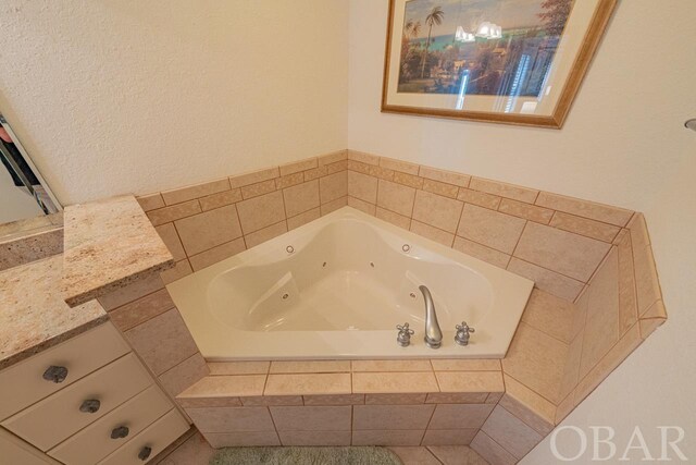 bathroom featuring vanity and a whirlpool tub