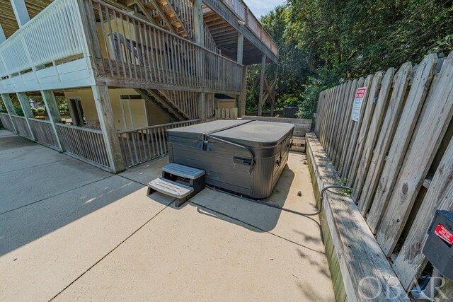 exterior space featuring a patio and a hot tub