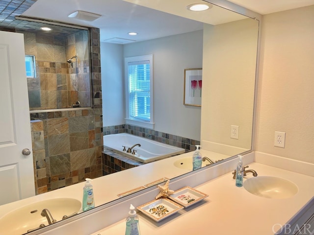 full bathroom with recessed lighting, a garden tub, vanity, and a shower stall