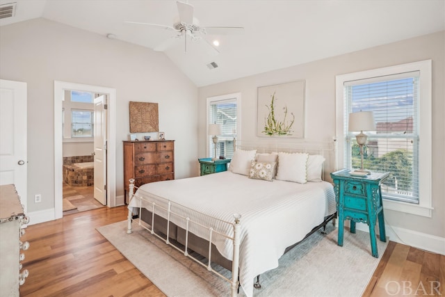 bedroom featuring lofted ceiling, visible vents, and wood finished floors