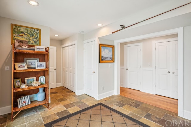 interior space featuring stone tile floors, baseboards, and recessed lighting