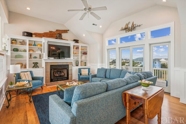 living room with a fireplace, recessed lighting, visible vents, light wood-style floors, and a ceiling fan