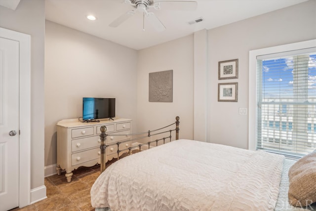 bedroom featuring a ceiling fan, multiple windows, visible vents, and baseboards