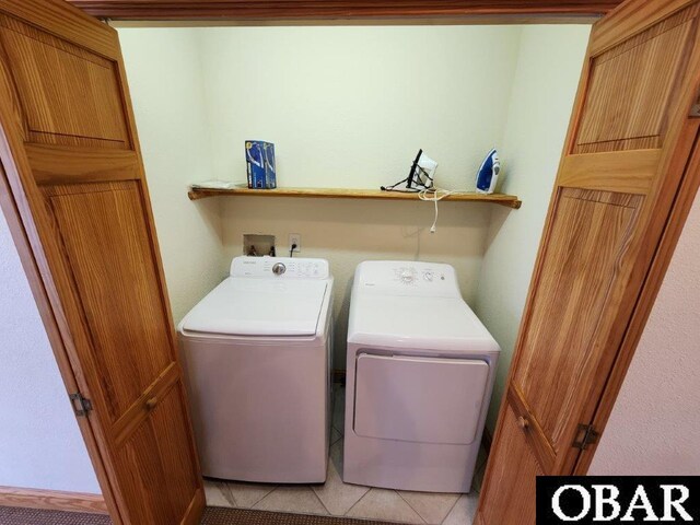 washroom with laundry area, light tile patterned flooring, and separate washer and dryer