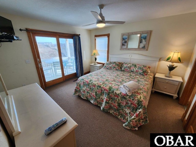 bedroom featuring access to exterior, dark colored carpet, and a ceiling fan