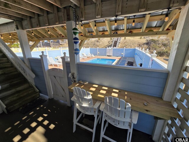 view of patio / terrace with a community pool and a hot tub