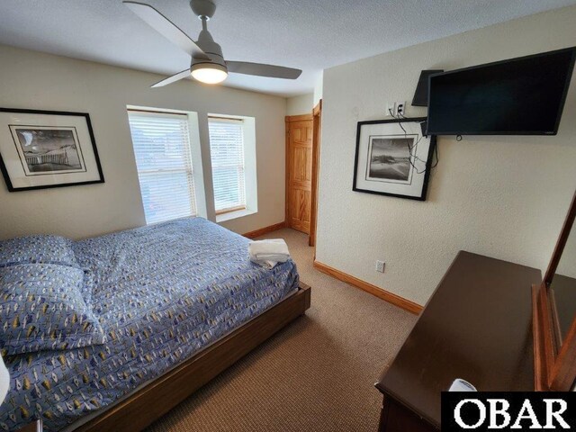 bedroom with a ceiling fan, carpet, a textured ceiling, and baseboards