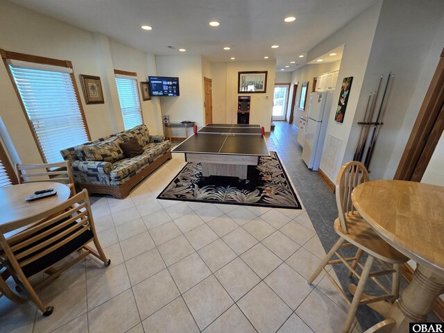 living room with light tile patterned floors and recessed lighting