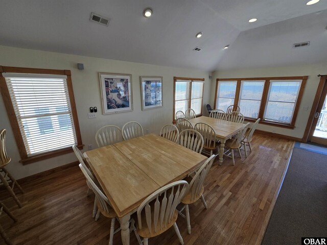 dining space featuring lofted ceiling, visible vents, dark wood-style flooring, and recessed lighting