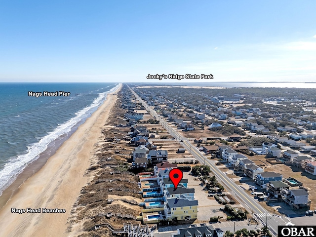 birds eye view of property featuring a residential view, a water view, and a beach view