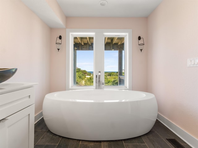 1556 Sandpiper Rd Lot # 33, Corolla, NC 27927 - bathroom with visible vents, baseboards, a soaking tub, and vanity