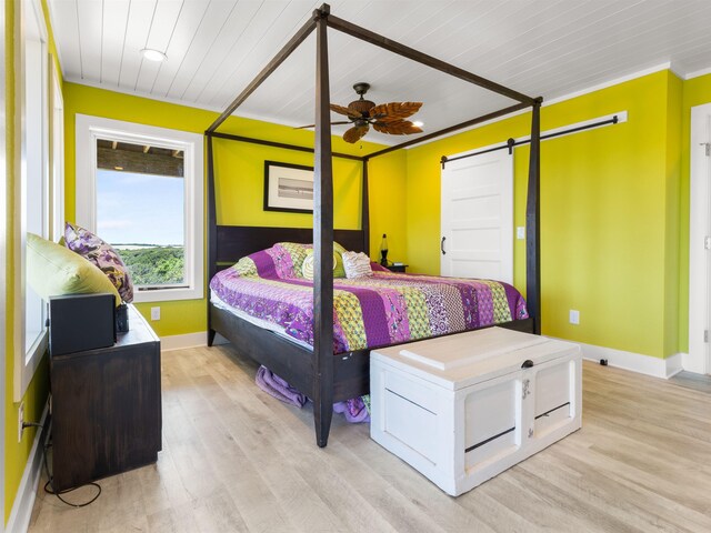 1556 Sandpiper Rd Lot # 33, Corolla, NC 27927 - bedroom featuring baseboards, light wood-type flooring, wooden ceiling, and a barn door