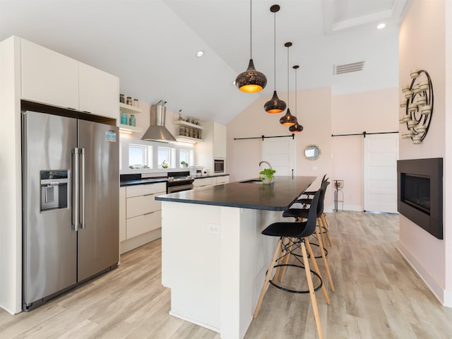 1556 Sandpiper Rd Lot # 33, Corolla, NC 27927 - kitchen featuring visible vents, stainless steel refrigerator with ice dispenser, a barn door, a sink, and dark countertops