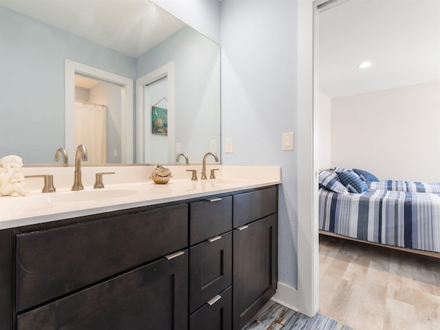 1556 Sandpiper Rd Lot # 33, Corolla, NC 27927 - bathroom featuring wood finished floors, double vanity, a sink, and baseboards
