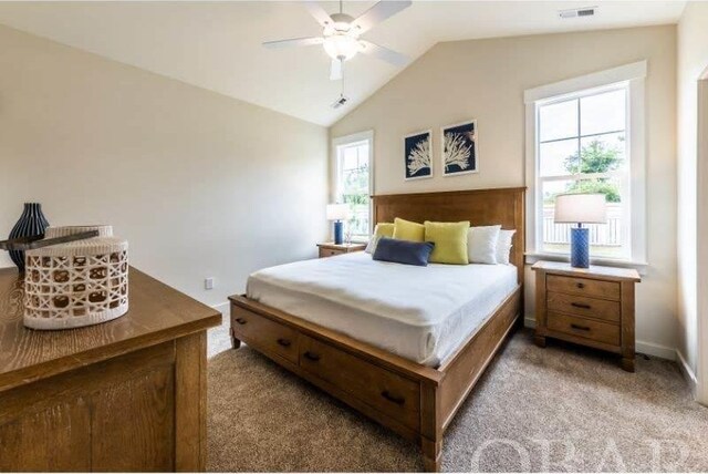 bedroom with lofted ceiling, baseboards, light carpet, and visible vents