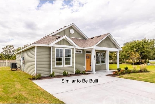 view of front of property featuring a shingled roof, board and batten siding, a front yard, and central air condition unit