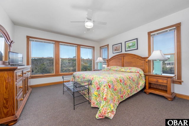 carpeted bedroom with a ceiling fan and baseboards