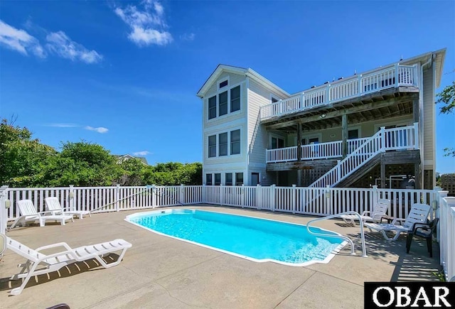 community pool featuring a patio area and fence