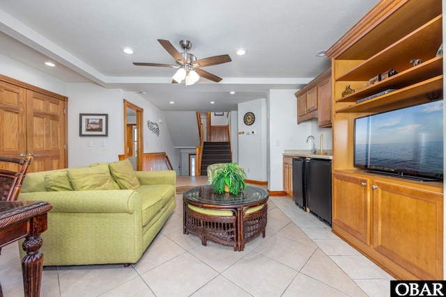 living area featuring ceiling fan, light tile patterned floors, recessed lighting, stairs, and wet bar