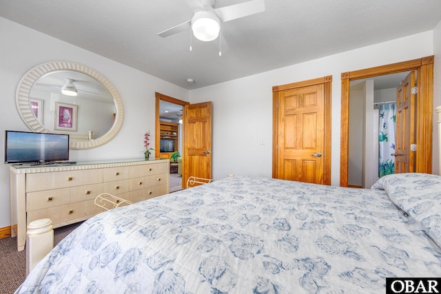 bedroom featuring a textured ceiling, carpet flooring, and a ceiling fan