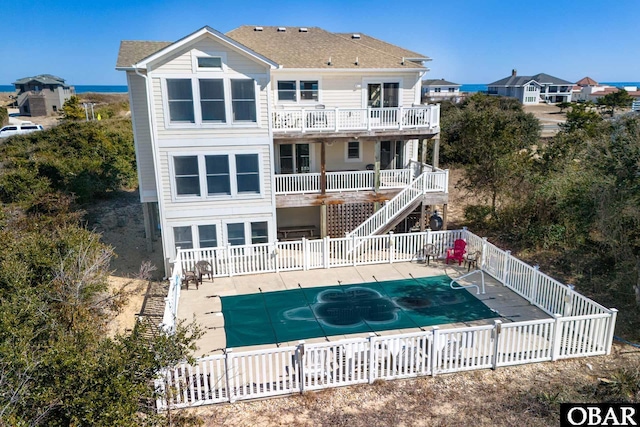 back of house featuring a patio area, fence, and a fenced in pool