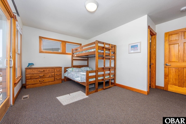 bedroom featuring baseboards, multiple windows, visible vents, and dark colored carpet