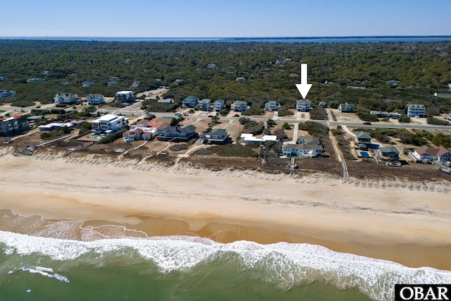 birds eye view of property featuring a water view and a view of the beach