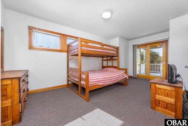 bedroom featuring access to outside, dark carpet, and baseboards