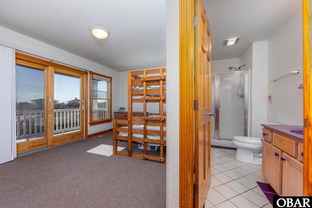 full bathroom with vanity, a shower stall, toilet, and tile patterned floors