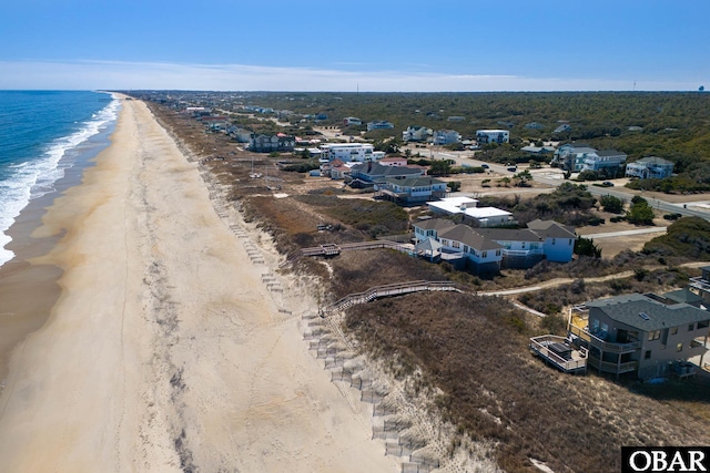 aerial view with a water view and a view of the beach