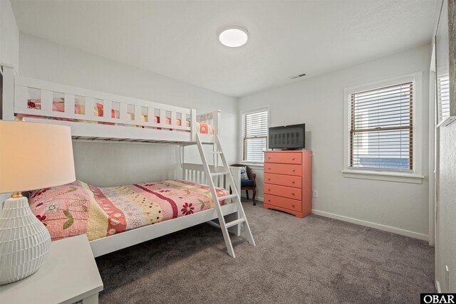 carpeted bedroom with baseboards and visible vents