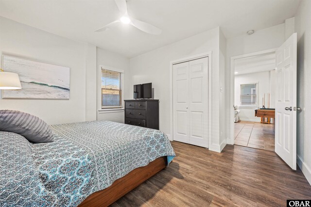 bedroom with ceiling fan, a closet, baseboards, and wood finished floors