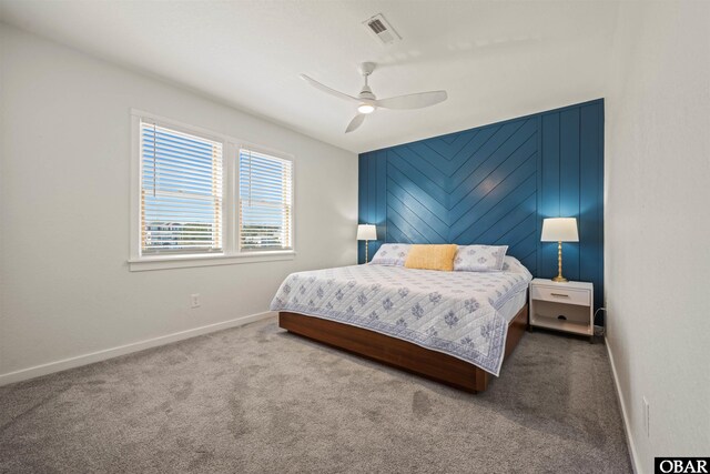 carpeted bedroom featuring baseboards, visible vents, and ceiling fan