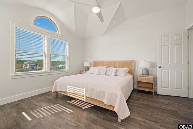 bedroom with a ceiling fan, dark wood-style flooring, vaulted ceiling, and baseboards