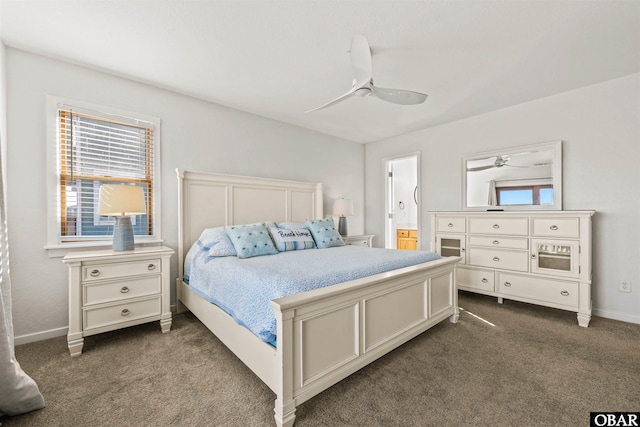 bedroom with baseboards, multiple windows, dark carpet, and a ceiling fan