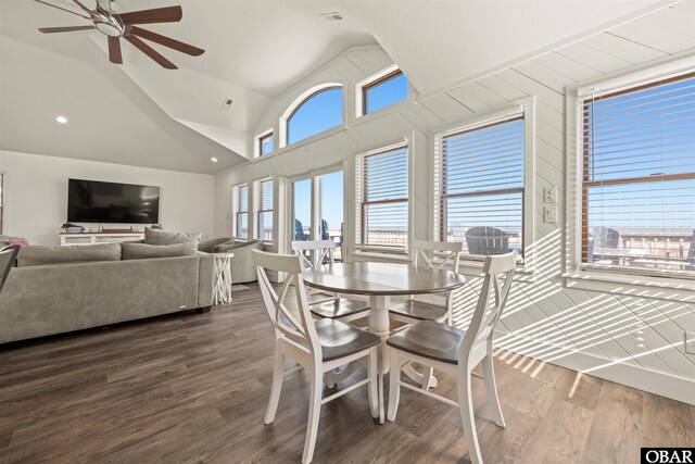 dining room featuring high vaulted ceiling, dark wood-style flooring, and a ceiling fan