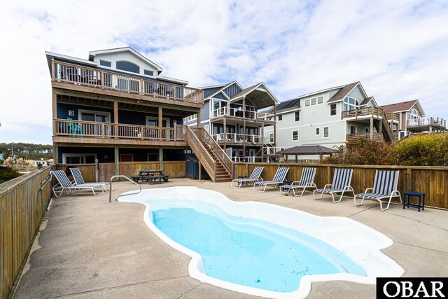 community pool with a patio area