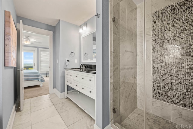 ensuite bathroom featuring marble finish floor, connected bathroom, vanity, a shower stall, and baseboards