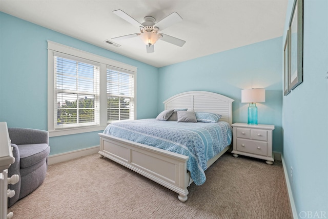 bedroom featuring light carpet, visible vents, and baseboards