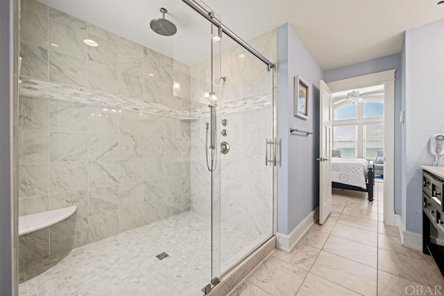 bathroom featuring ensuite bathroom, marble finish floor, a shower stall, and baseboards