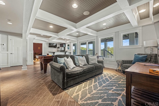 living area with beam ceiling, coffered ceiling, dark wood finished floors, and ornate columns