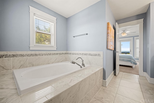 full bathroom with ensuite bath, baseboards, and a bath