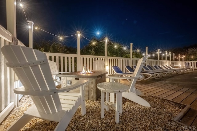 deck at twilight featuring a fire pit