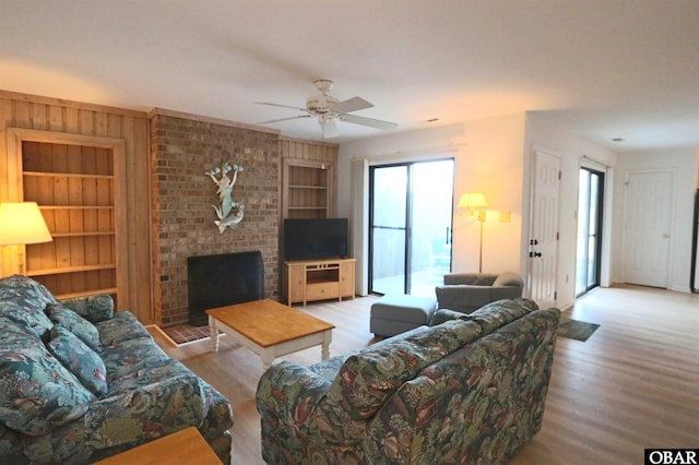 1006 Swordfish Way Unit 1006, Kitty Hawk, NC 27949 - living area featuring built in features, wood finished floors, a ceiling fan, and a fireplace
