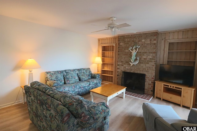 1006 Swordfish Way Unit 1006, Kitty Hawk, NC 27949 - living area with built in features, wood finished floors, baseboards, ceiling fan, and a brick fireplace